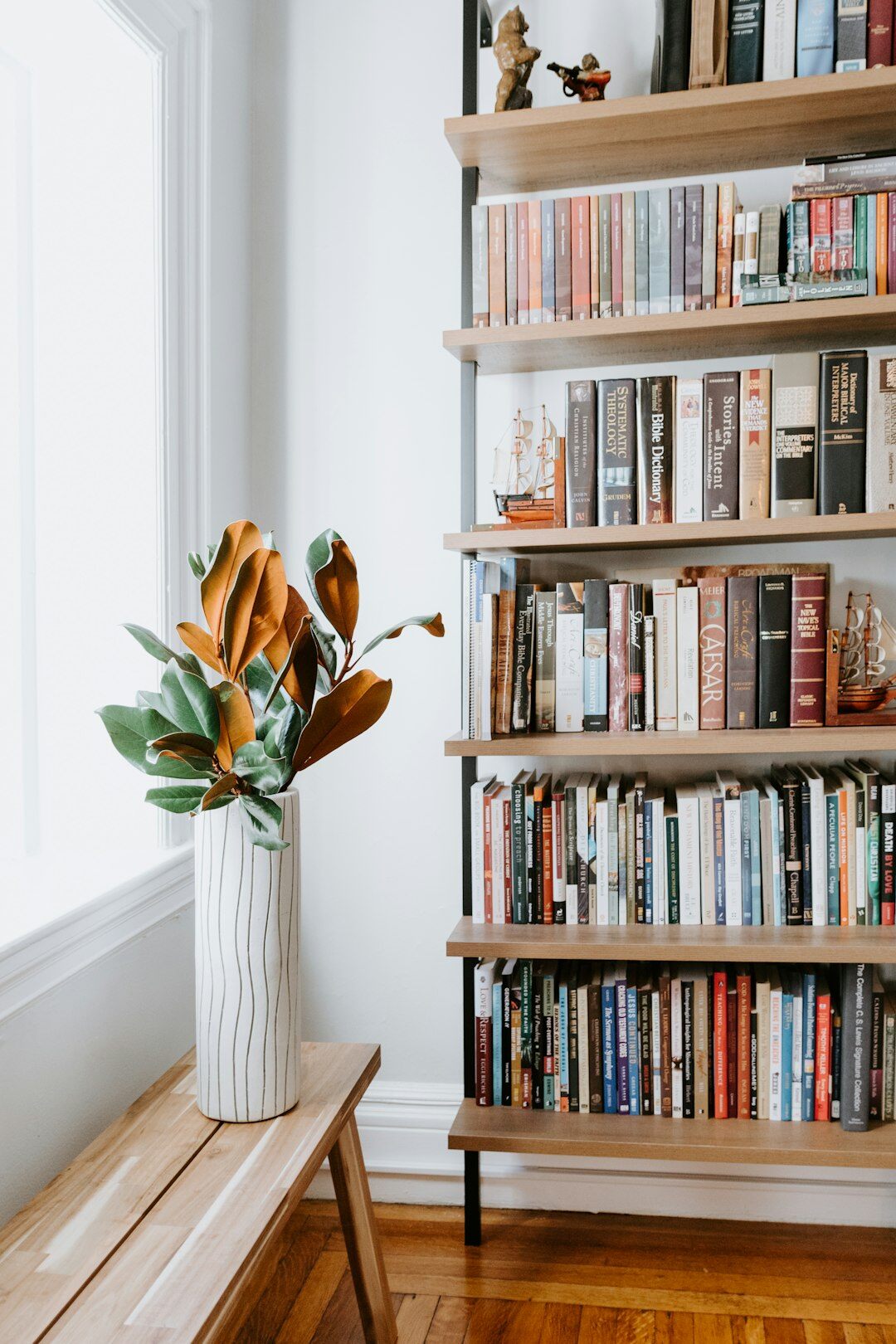 Wooden bookshelf filled with hardcover mystery and crime novels