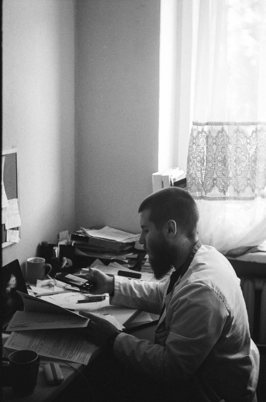 Middle-aged Croatian male mystery writer sitting at a wooden desk with a typewriter