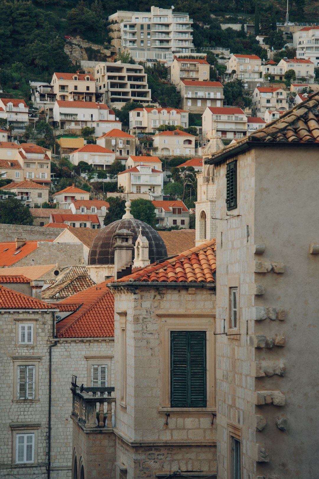 Narrow cobblestone alley between old stone houses in a Croatian coastal town at dusk